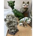A Mosanic pottery cat with a green glass eyes and open mouth together with a majolica lion,