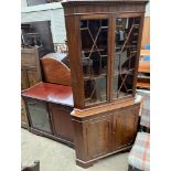 A reproduction mahogany standing corner cupboard, the top with a pair of astragal glazed doors,