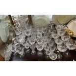 Assorted crystal drinking glasses together with a cruet, ice bucket,