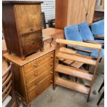 An oak chest of drawers together with an oak bookcase, a sewing cabinet,