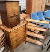 An oak chest of drawers together with an oak bookcase, a sewing cabinet,