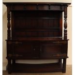 An early 20th century oak dresser with a moulded cornice above a plate rack,