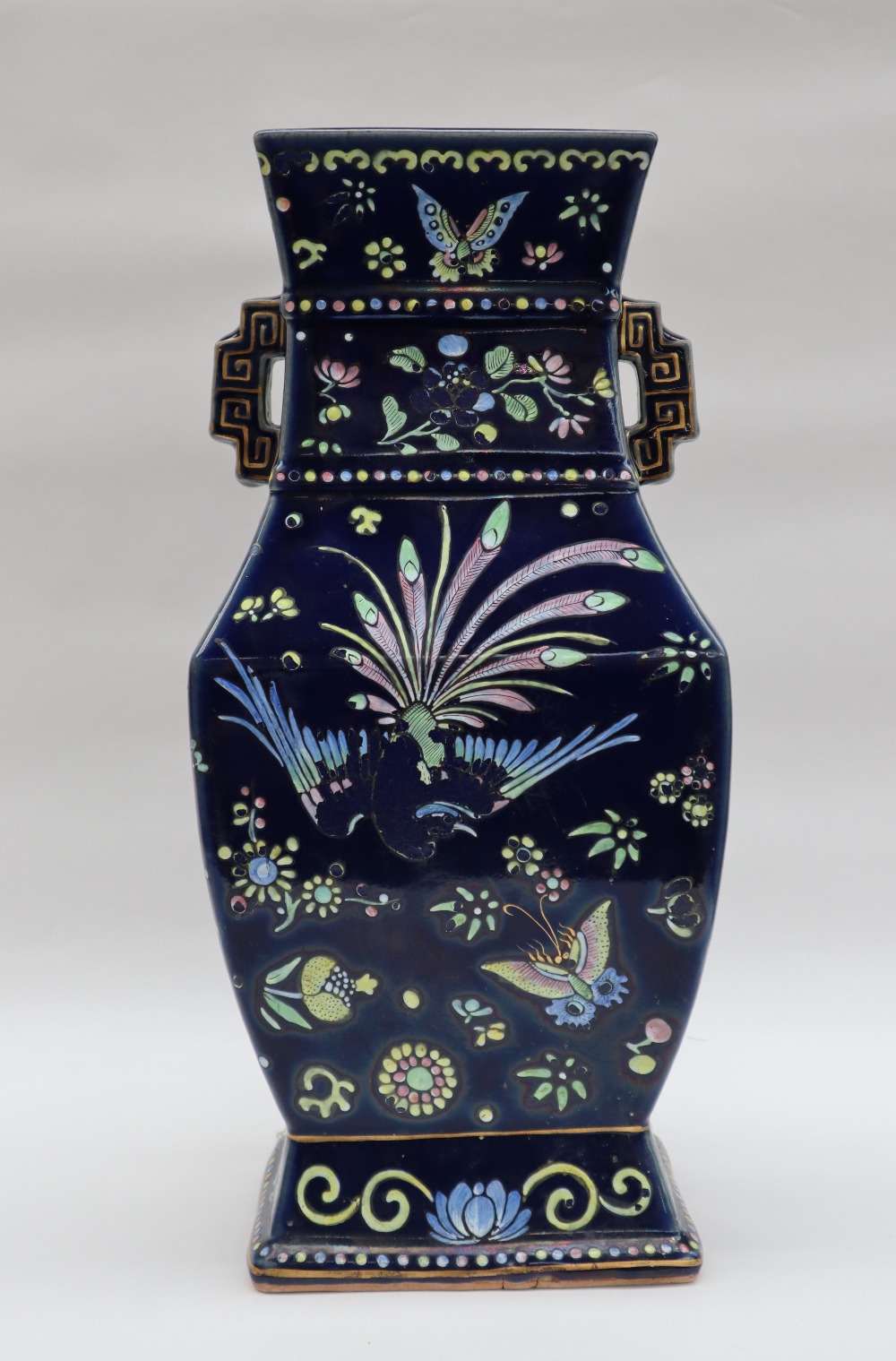 A large Chinese porcelain twin handled vase of rectangular baluster form with a royal blue ground