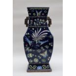 A large Chinese porcelain twin handled vase of rectangular baluster form with a royal blue ground