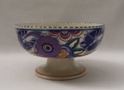 A Poole pottery pedestal bowl, the exterior decorated with blue birds and flower heads,