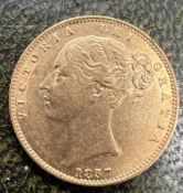 A Victorian young head shield back gold sovereign dated 1857