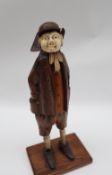 A 19th century continental carved figure, with carved bone face, tie and legs,