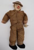 A World War II Oliver "Hardy" Tommy clown doll, in British uniform with steel helmet,