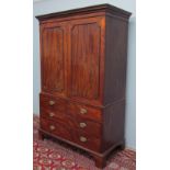 A 19th century mahogany linen press with a moulded cornice above a pair of panelled doors enclosing