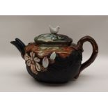 A Japanese Sumida Gowa pottery teapot with a dove finial,