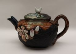 A Japanese Sumida Gowa pottery teapot with a dove finial,