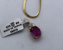 Gemporia - a 9ct gold pink fluorite and white zircon pendant on a yellow metal chain