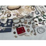 Assorted costume jewellery including necklaces, brooches, faux pearls, bracelets, stick pins, rings,