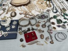 Assorted costume jewellery including necklaces, brooches, faux pearls, bracelets, stick pins, rings,