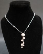 An 18ct white gold diamond set waterfall pendant, on a rub over set diamond chain,