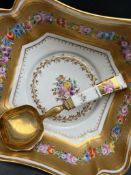 A French porcelain salad bowl, decorated with swags of flowers within a gilt border,