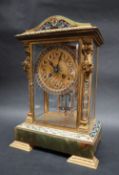 An early 20th century French gilt metal champleve enamel and onyx four glass mantle clock,