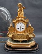 A 19th century gilt metal mantle clock with cupid surmount, the enamel dial with Roman numerals,