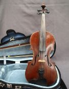 A late 19th century violin, with a one piece back and ebonised stringing,