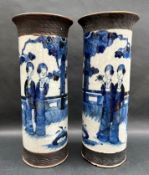 A pair of Chinese porcelain blue and white vases of cylindrical form decorated with Oriental