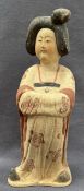 A Chinese pottery Tang style figure of a Court Maiden, wearing a floral gown,