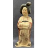 A Chinese pottery Tang style figure of a Court Maiden, wearing a floral gown,