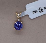 Gemporia - An 18ct gold Tanzanite and diamond Tomas Rae pendant, with a round 1.