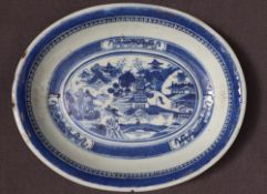A Chinese porcelain dish of oval form decorated with a landscape scene to the centre,