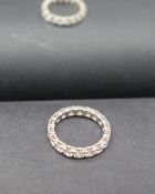 A diamond full eternity ring set with round old cut diamonds to a white metal setting,
