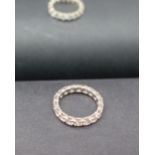 A diamond full eternity ring set with round old cut diamonds to a white metal setting,