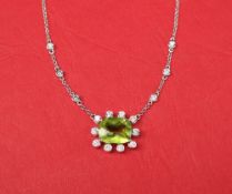 A peridot and diamond pendant,