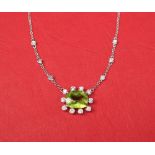 A peridot and diamond pendant,