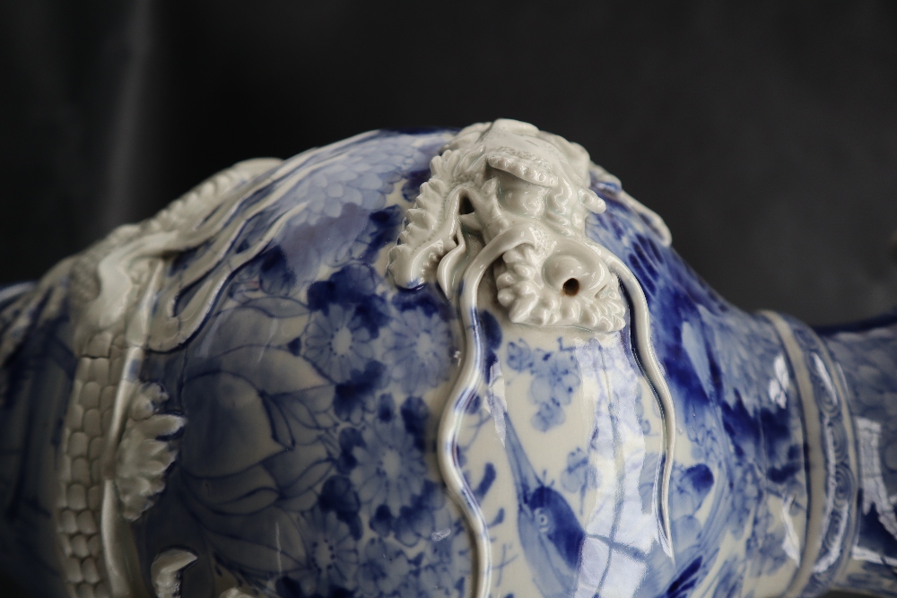 A Japanese blue and white porcelain vase decorated with a raised dragon encircling the vase further - Image 6 of 6