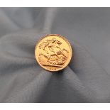 A George V gold Sovereign dated 1918 affixed to a yellow metal ring mount,