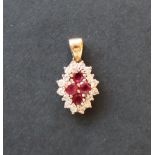 A diamond and a red spinel pendant,