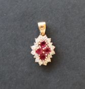A diamond and a red spinel pendant,