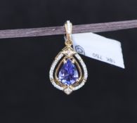 Gemporia - An 18ct gold Tanzanite and diamond Tomas Rae pendant, with a pear cut 1.