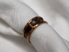 A 19th century 18ct gold Momento Mori ring with black enamel band "IN MEMORY OF" and panel with