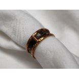 A 19th century 18ct gold Momento Mori ring with black enamel band "IN MEMORY OF" and panel with