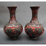 A pair of Japanese two tone lacquer baluster vases decorated with chrysanthemums and other flowers,