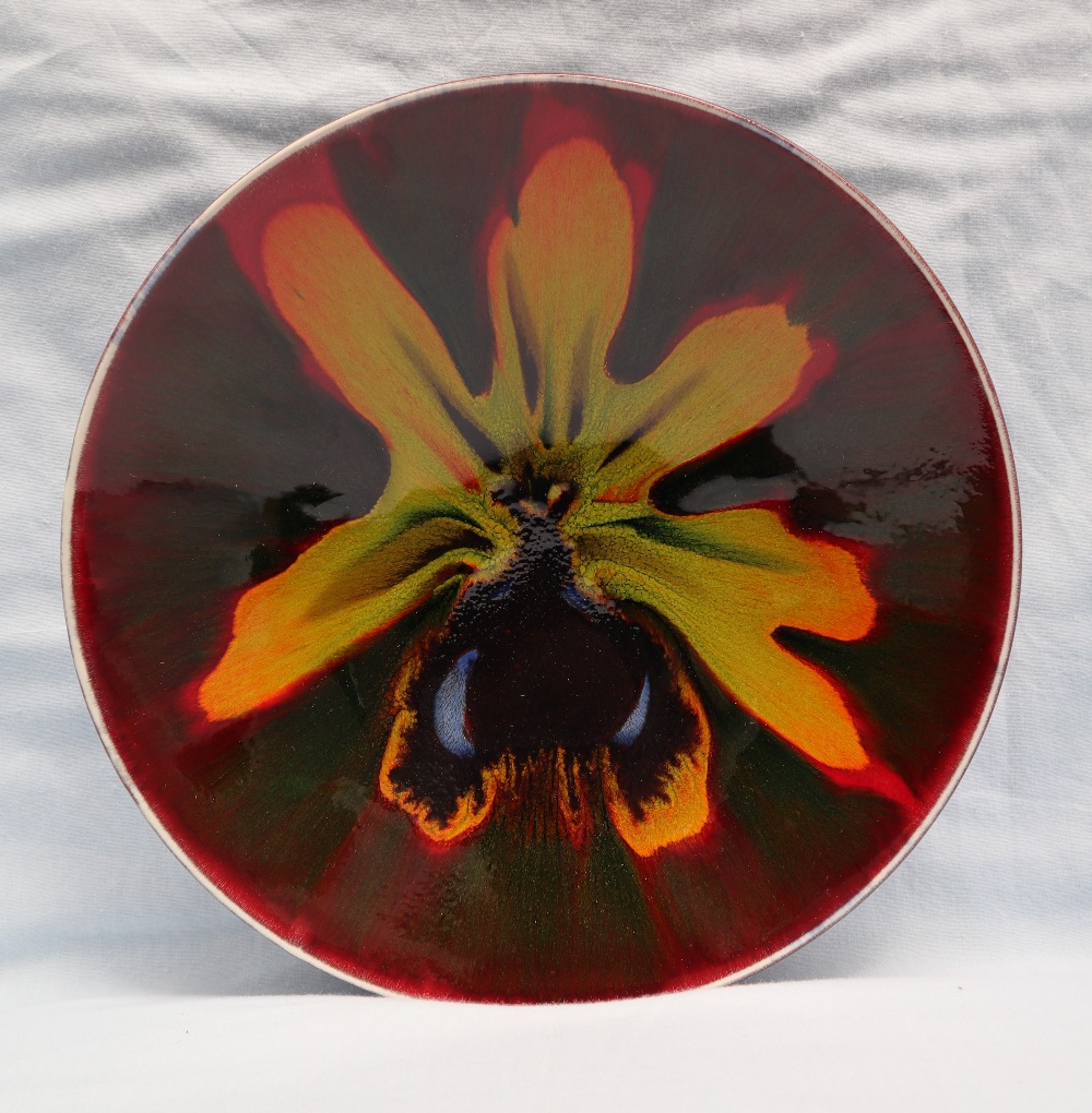 Poole pottery studio plate decorated with a "spider orchid", printed mark,