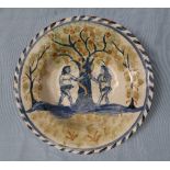 A tin glazed earthenware bowl with blue dash border decorated with Adam and Eve in the garden of