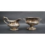A Russian silver twin handled sugar basin of lobed form on a pedestal foot together with a similar