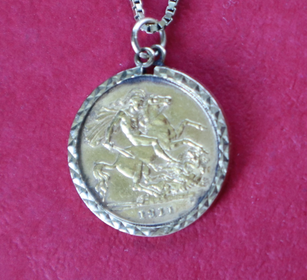 A George V gold half sovereign, dated 1911 in a 9ct gold mount on a 9ct gold chain,