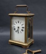 A brass cased carriage clock, with an enamel dial and Roman numerals, 14.