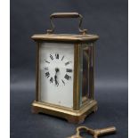 A brass cased carriage clock, with an enamel dial and Roman numerals, 14.