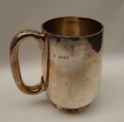 A Victorian silver tankard of cylindrical form on a spreading foot, London, 1886,