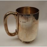 A Victorian silver tankard of cylindrical form on a spreading foot, London, 1886,