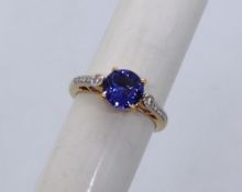 Gemporia - An 18ct gold Tanzanite and diamond Tomas Rae ring, with a round 1.