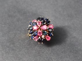 A ruby, sapphire and diamond cluster ring, set to a yellow metal setting and shank marked 18k,